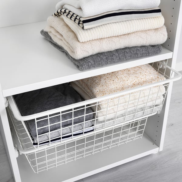 Wire basket on shelf, stores neatly folded clothes. Allows air circulation, rolls for easy access.