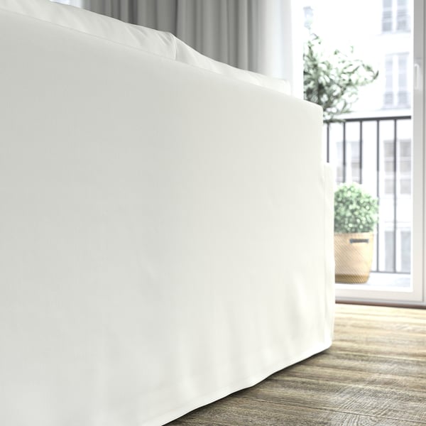 A white sofa-bed with cushions, near a window with a plant, showcasing its comfortable and clean design.