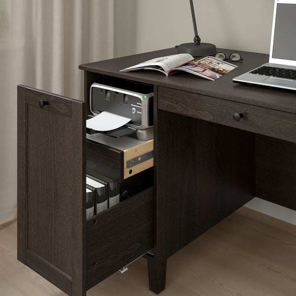 Dark wooden desk with open drawer revealing printer and organised files, featuring built-in storage and cable management.