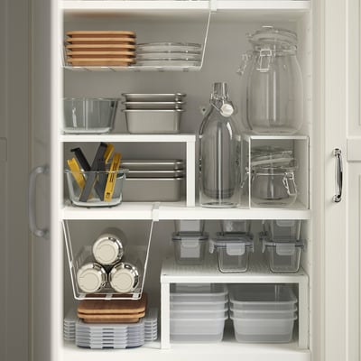 Kitchen cabinet with IKEA 365+ containers neatly storing food, utensils, and tools.