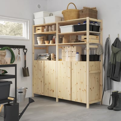 Wooden IVAR shelves hold gardening tools and supplies. Tall, light pine with various baskets and containers, fitting neatly next to coats and boots.