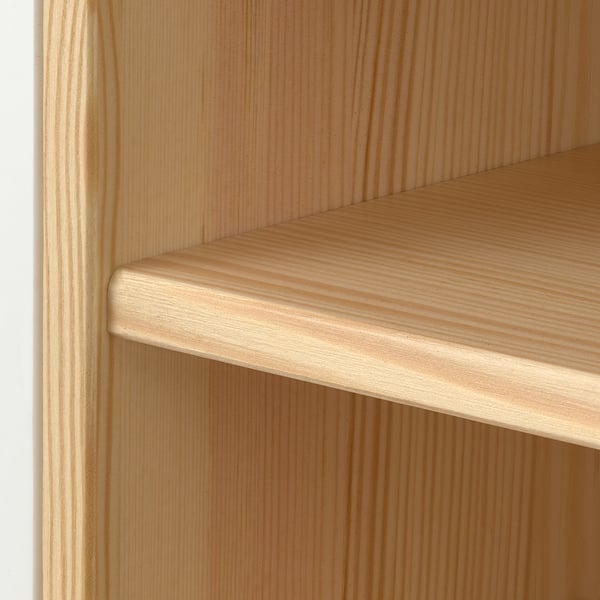 Close-up of pine wood shelf, smooth finish, natural grain visible.