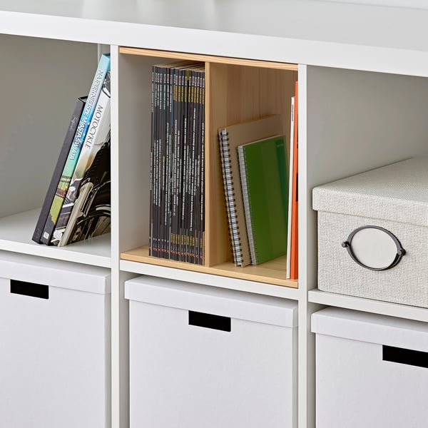 White KALLAX shelf with pine inserts dividing books and binders, providing extra storage and organisation.