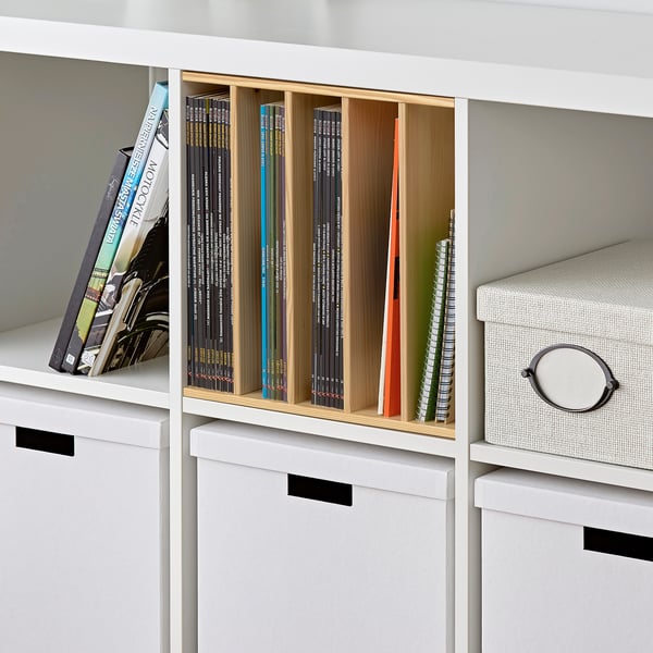 Wooden book divider fits white shelf, creates four sections, organises books vertically.