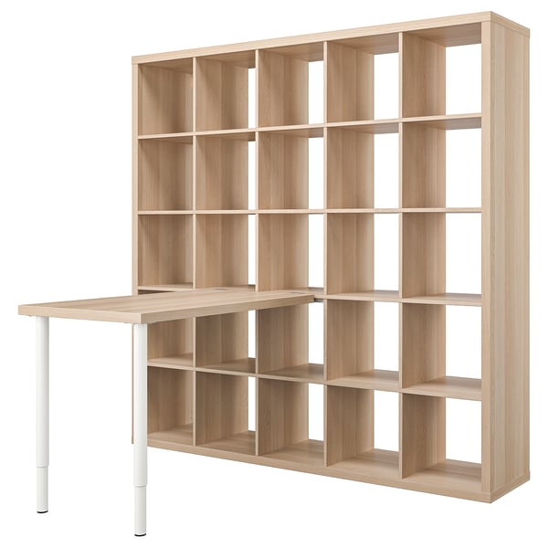 A light wooden KALLAX bookshelf with storage cubes and a desk extension. It has a minimalist and modern design.