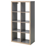 Displays an empty grey KALLAX shelf unit with multiple compartments, featuring a modern and minimalist design.
