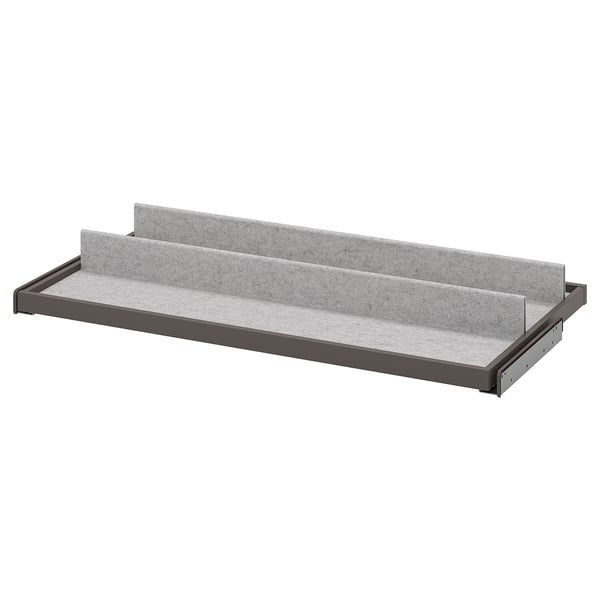 A grey KOMPLEMENT pull-out tray with felt lining for organising items in a wardrobe.