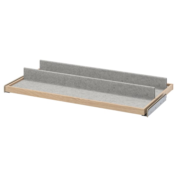 An IKEA KOMPLEMENT pull-out drawer organiser with wooden frame and grey felt trays for storage.