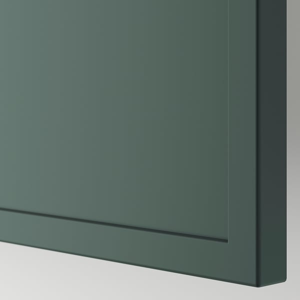 Close-up of sleek, grey-green drawer front with smooth finish and modern frame.