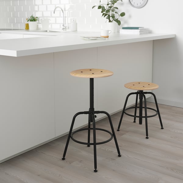 Two KULLABERG stools with black metal bases under kitchen island, adjustable heights.