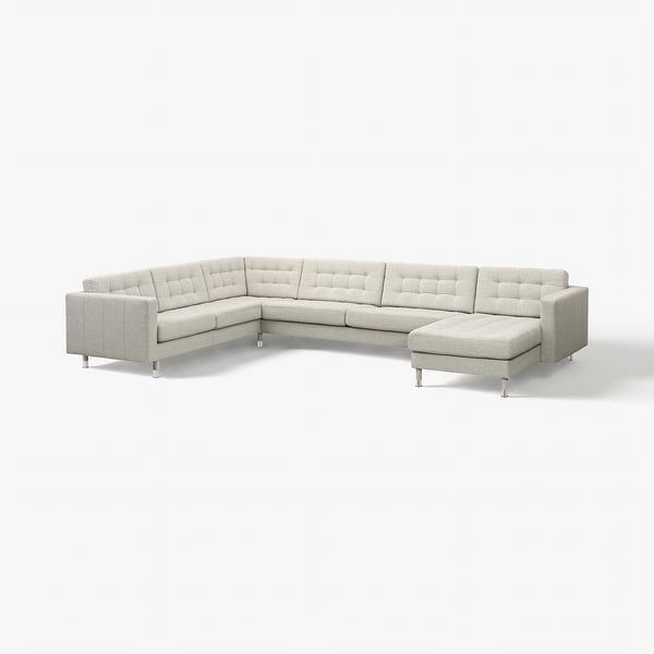 Modern grey l-shaped sectional sofa with chrome legs and tufted back and seats.