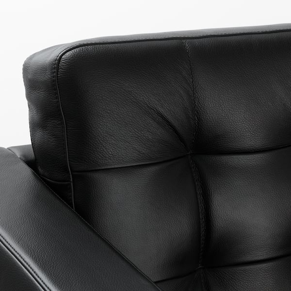 Close-up of a high-quality black leather chair, showcasing smooth, durable material and intricate stitching detail.