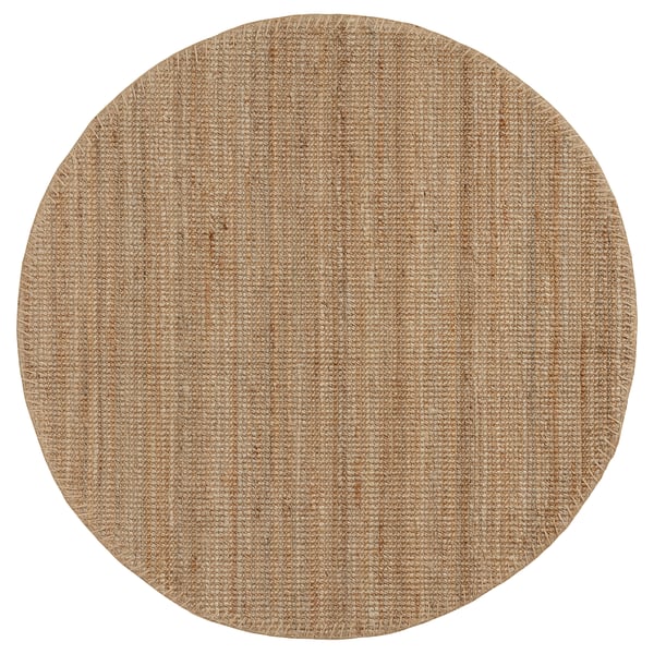 A circular LOHALS rug in natural jute tones, featuring a flat-woven, textured design.
