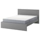 Grey MALM bed with white mattress, minimalist design.