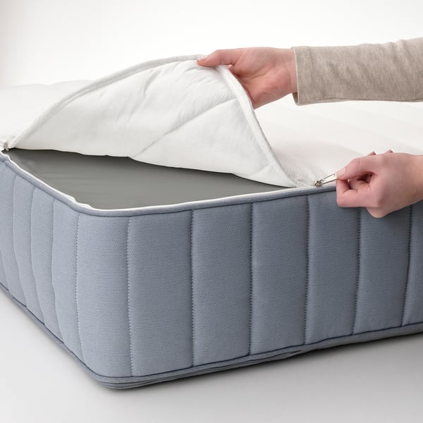 Person opening light grey MALM bed storage box, showing easy access to storage space.