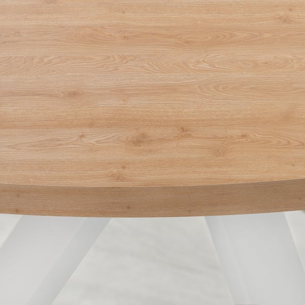 Close-up of a light wooden tabletop. Visible wood grain texture, smooth finish, showing durability and fine craftsmanship.