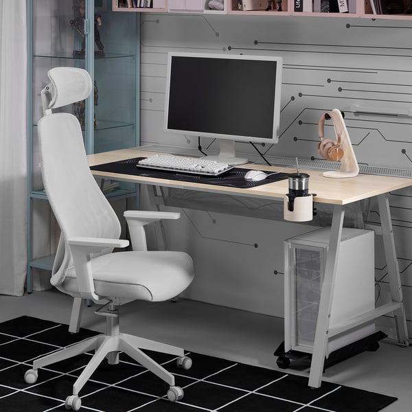 Minimalist home office with MATCHSPEL gaming chair, monitor, cup, and headphones.