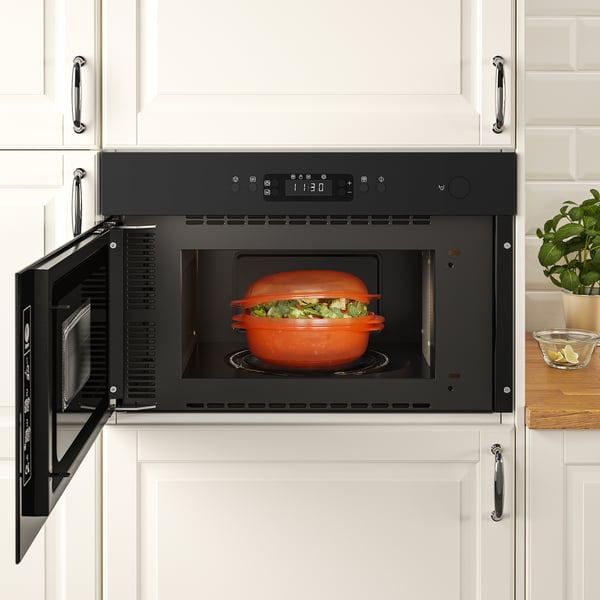 Modern kitchen with MATTRADITION microwave, cooking broccoli.