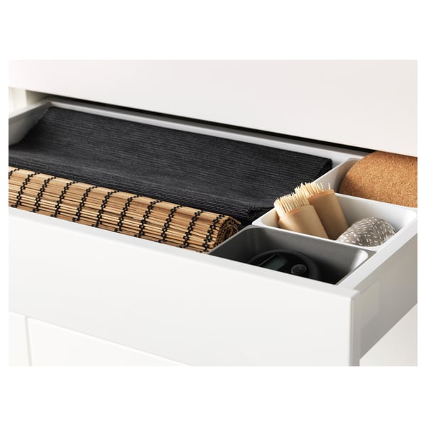 White drawer open showing black organiser, cleaning brushes, and sponges.