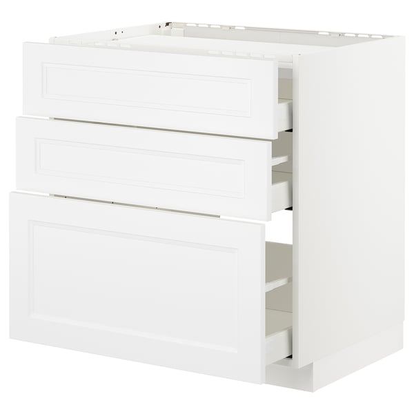 White kitchen cabinet, three open drawers, modern minimal design, made of fibreboard and steel.