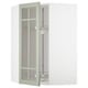 A light green glass door kitchen cabinet from IKEAs METOD system, featuring a sleek design with adjustable shelves.