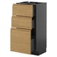 Modern kitchen unit with dark gray base and light brown oak drawers, sleek and minimalist design.