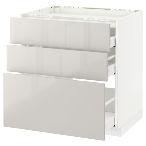 White high-gloss kitchen cabinet with three open drawers.