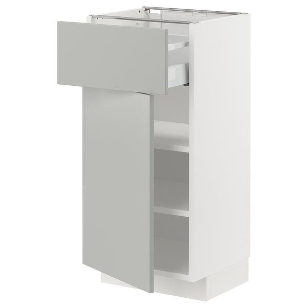 A white METOD kitchen cabinet with a sleek light grey havstorp drawer and door, featuring modern clean lines.