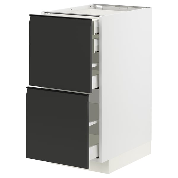 White METOD kitchen unit with black drawers.