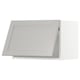 Modern kitchen cabinet in light grey with beveled edges.