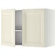 An off-white METOD kitchen wall cabinet with beveled edges and an open door revealing an adjustable shelf and a steel dish drainer.