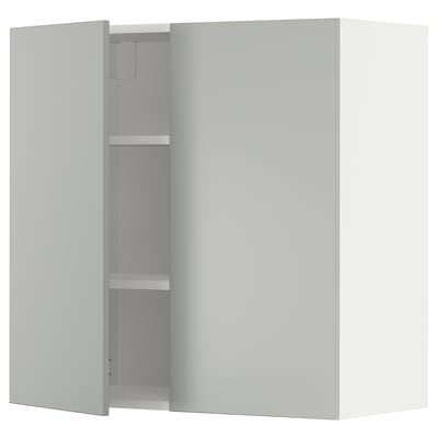 A white METOD wall cabinet with two doors and two shelves. The cabinet is modern and minimalist in design, featuring clean lines and a sleek finish.
