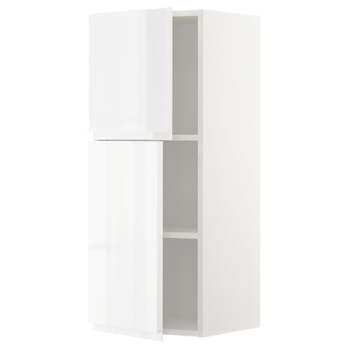 A white METOD kitchen cabinet with two adjustable shelves and integrated handles. Modern and minimalist, it a high gloss finish.