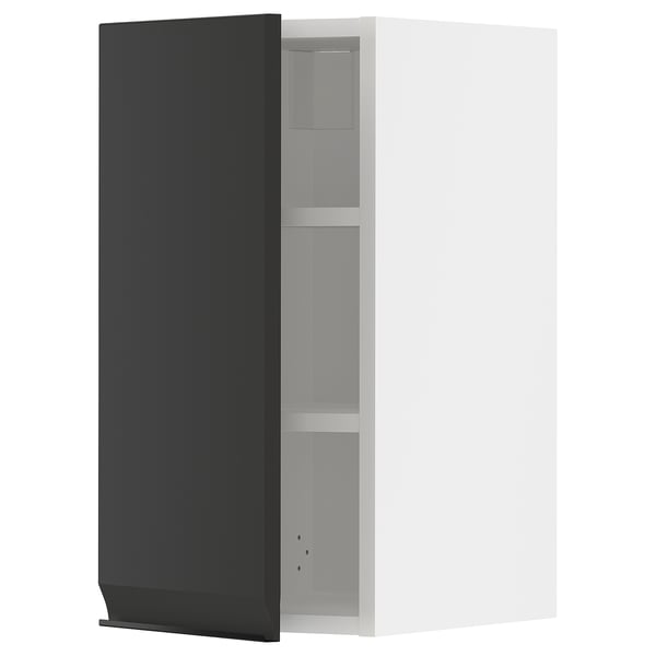A modern, black METOD kitchen wall cabinet with a sleek, minimalistic design featuring a door and adjustable shelves.