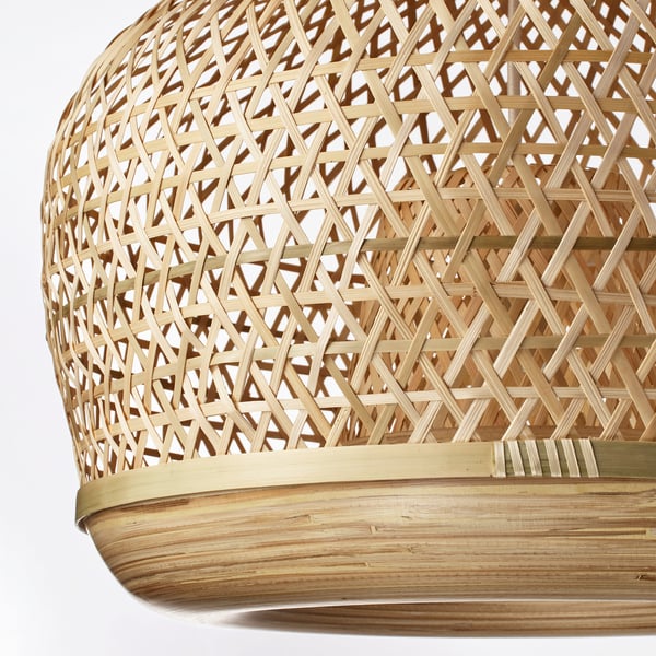 Handwoven bamboo pendant lamp with intricate lattice pattern, natural variations, and warm, soft glowing light.