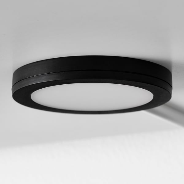Modern circular ceiling light, sleek black frame, bright centre.