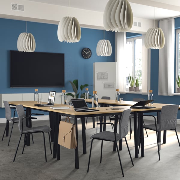 Modern MITTZON white conference table with grey chairs, wide & spacious, beneath unique pendant lamps. Ideal for meetings.