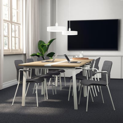 MITTZON conference table: modern, rectangular, wooden top with metal base, surrounded by black fabric chairs, and a large tv. Ideal for meetings.