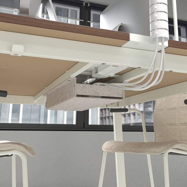 Modern office table with cable management, set up for meetings or work.