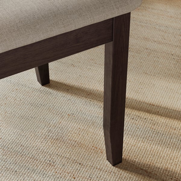 Close-up of stylish chair leg, smooth finish, dark wood veneer, sturdy craftsmanship on beige rug.