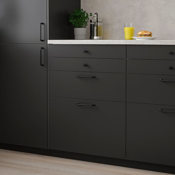 Modern kitchen with dark grey NICKEBO cabinets. Smooth finish, minimalist design. Cabinets sized larger than counter items.