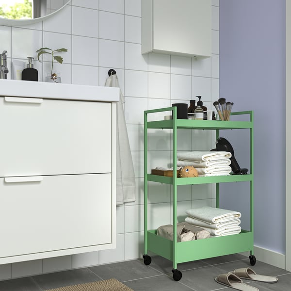 NISSAFORS green metal storage trolley in bathroom, small, three shelves, holds towels, toiletries.