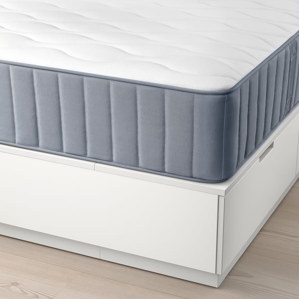 Close-up of NORDLI beds endless support mattress, showcasing pocket springs and soft-closing drawer for hidden storage.