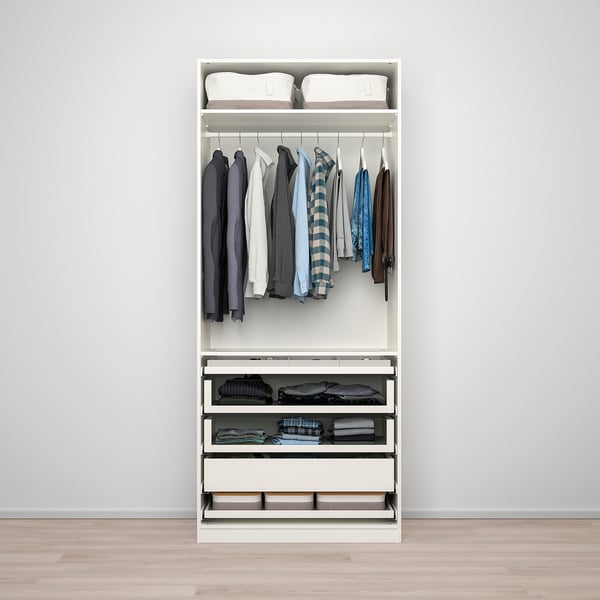 Minimalist wardrobe: hanging shirts, folded clothes, & storage drawers in a neat setup.