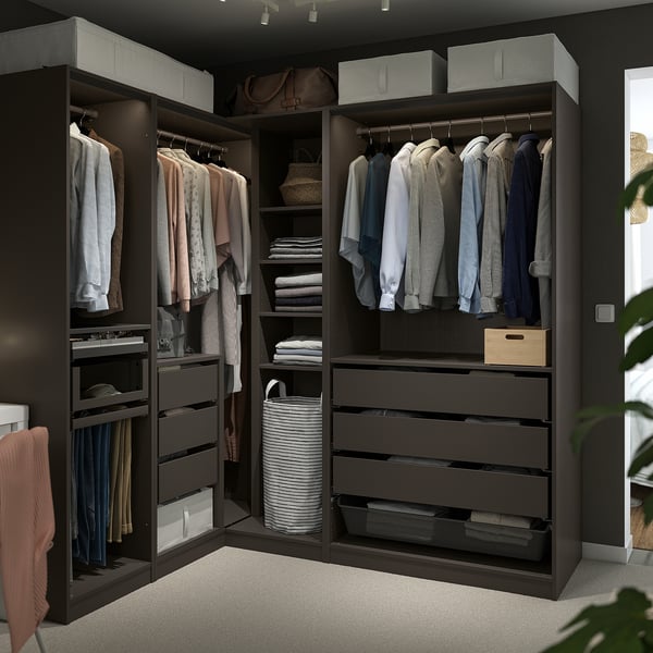 Large black PAX wardrobe, neatly organising clothes. Multiple shelves, drawers, and hanging spaces for efficient storage.