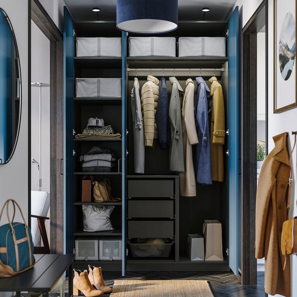 Open wardrobe showing clothing, shelves, and drawers, demonstrating organised storage with adjustable interiors.