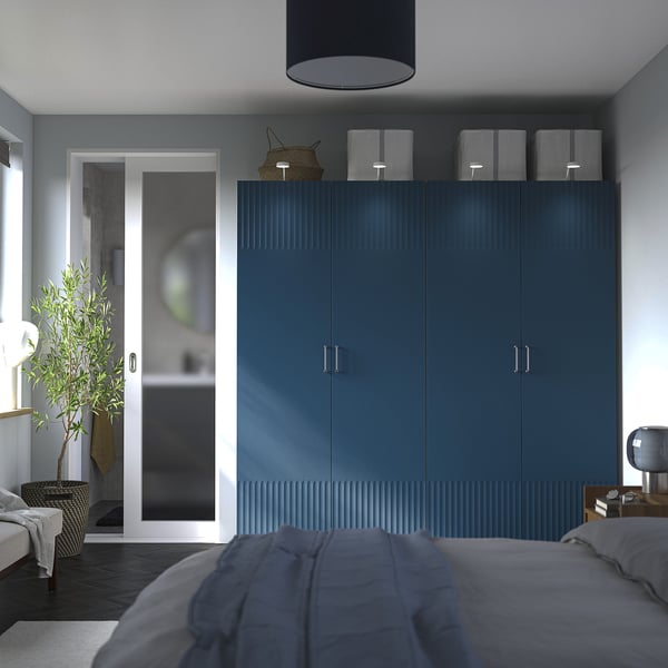 Modern bedroom with teal PAX wardrobe, grey bed, and bathroom view.