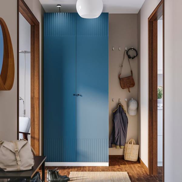 Large blue PAX wardrobe with textured doors and hooks.