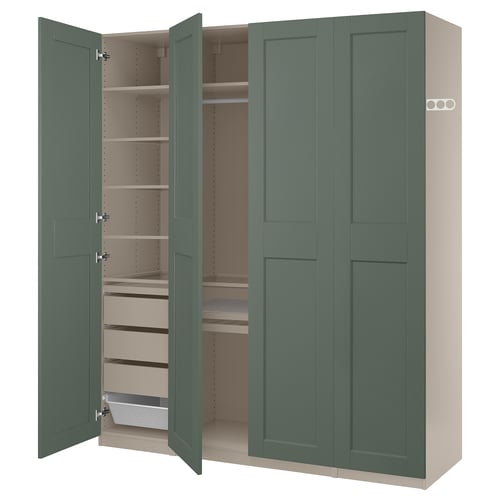 A green ikea PAX wardrobe with open doors, revealing shelves and storage inside.