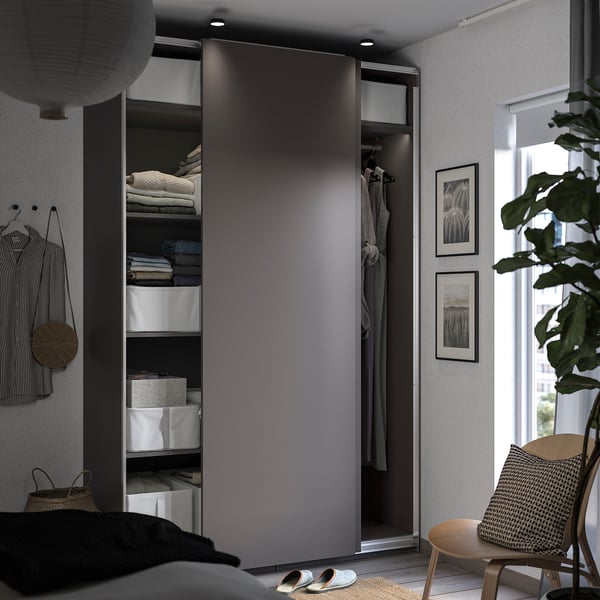 Modern grey sliding wardrobe, organised with shelves and hanging spaces. Clean lines and minimalist design.